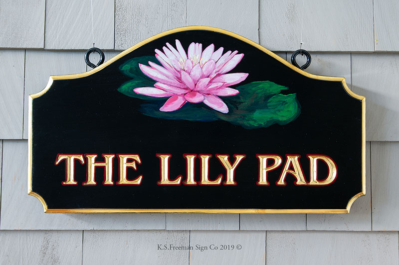 Carved home sign featuring a hand painted lily pad