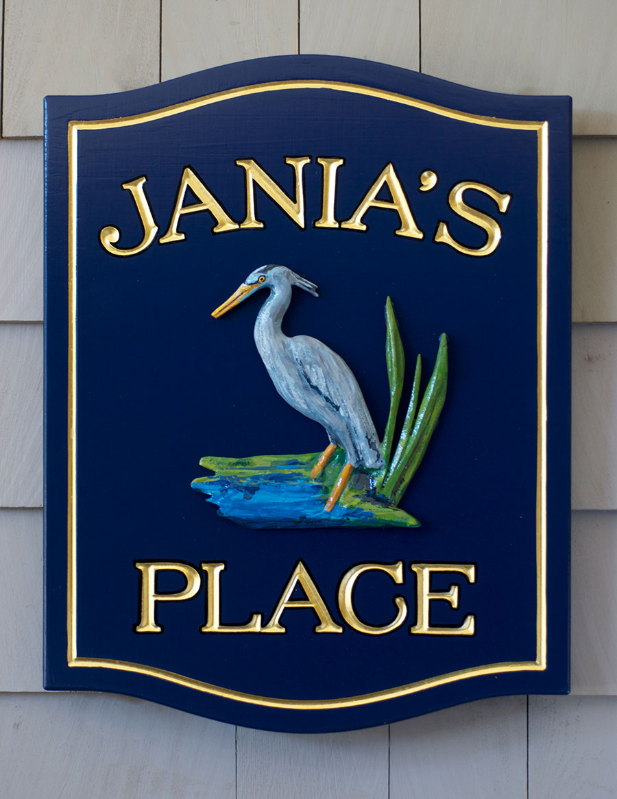 Carved home sign featuring a hand painted Blue Heron and tidal scene