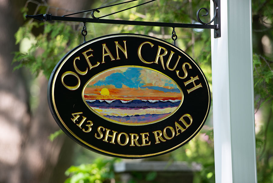 Carved home sign with hand painted ocean sunrise scene