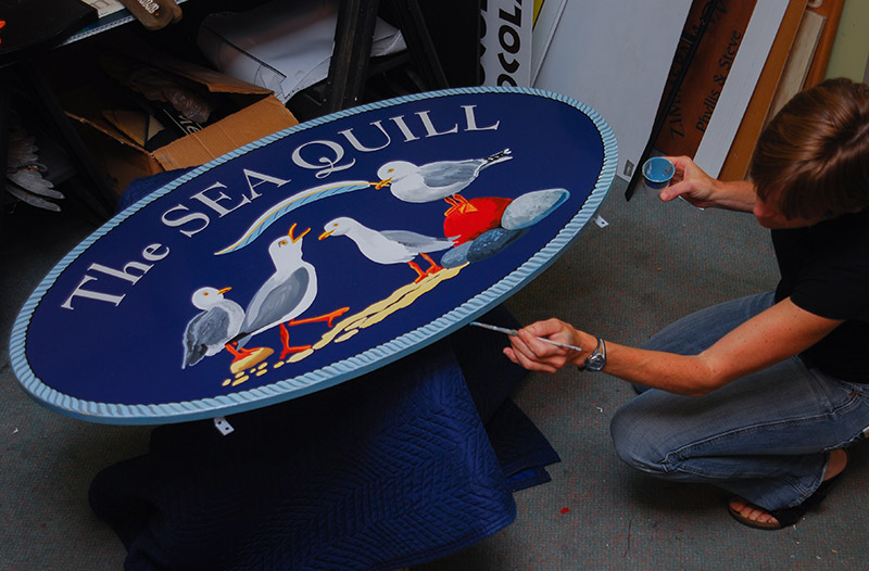 Hand painted seagulls on a custom cottage sign