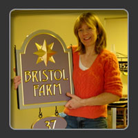 Sandra Freeman with a carved sign